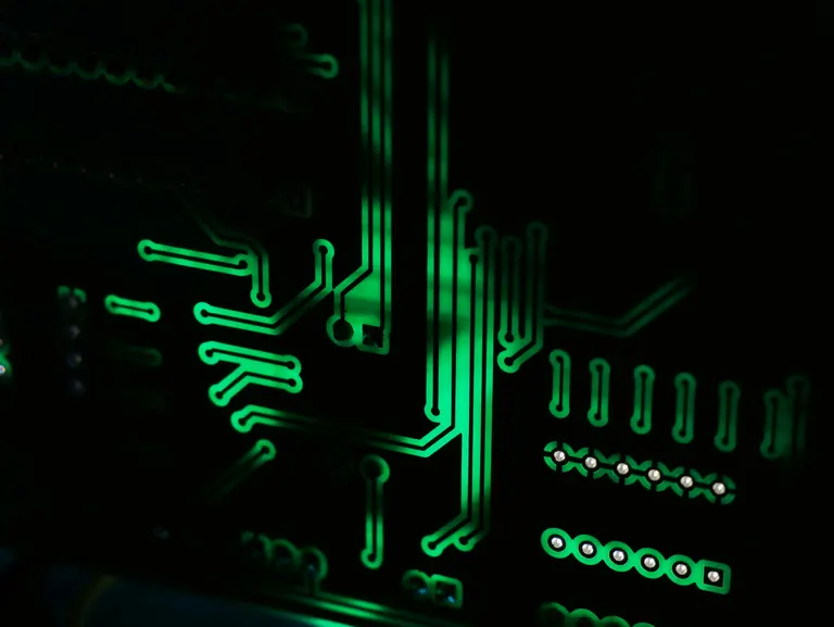 Close-up of a computer motherboard with gold contacts — genuine hardware parts by Chama Solution